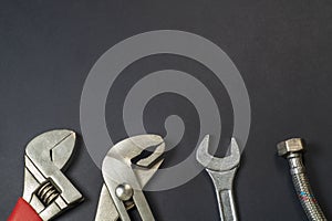 Necessary set of tools for plumbers on a black background