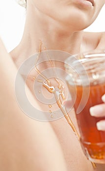 Neck of a beautiful girl with honey jar