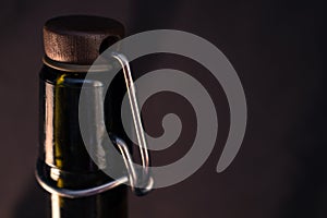 The neck of a bottle on a black background.