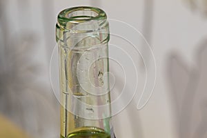 Neck glass bottle of wine, drops on the glass inside the bottle. opening of white wine