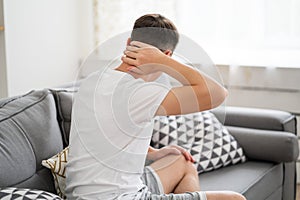 Neck pain, man suffering from ache at home