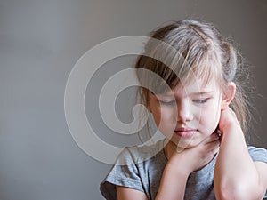 Neck pain. Portrait stressed unhappy child girl with back pain, Negative human emotions facial expression feeling.