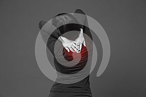 Neck pain, woman with backache on gray background