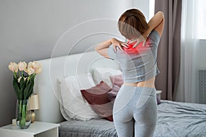 Neck pain, woman suffering from ache in the bedroom