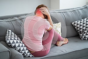 Neck pain, woman suffering from backache at home