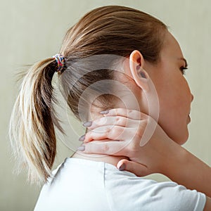 Neck shoulder pain, cervical vertebrae. Woman holds neck with pain cervical muscle spasm by hand. Disease of