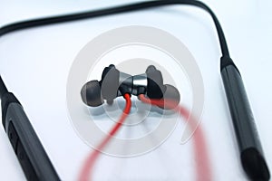 Neckband image. Bluetooth headset image. Red wired bluetooth earphones. Wireless headset photo