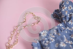 Necklace with floral dress  on table