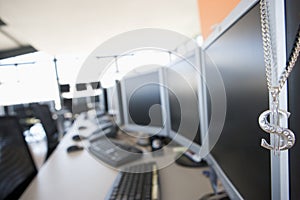 necklace hanging on monitor in computer room