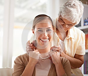 Necklace, jewellery and portrait of mother and woman for present, gift and surprise in living room. Family, pearls and