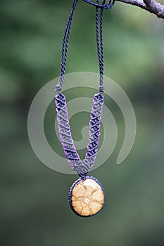 necklace on natural background with ayahuasca root decoration