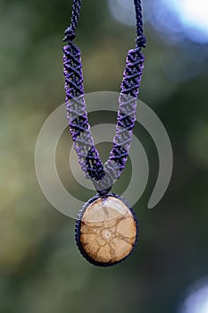 Necklace on natural background with ayahuasca root decoration