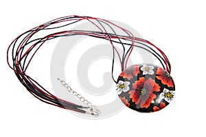 Necklace with round pendant isolated on white background. Red, black and yellow floral ornaments. Female accessories