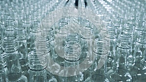 Necks of moving glass bottles in a close up