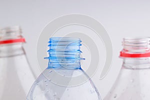 Necks of plastic bottles on a white background