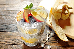 Nectarine and banana chia pudding on wooden background