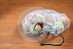 Nectarine in ecological packaging. Reusable bags for vegetables and fruits. Shopping in the store, retail. Eco friendly packaging