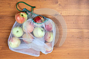 Nectarine in ecological packaging. Reusable bags for vegetables and fruits. Shopping in the store, retail. Eco friendly packaging