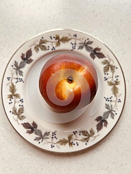 Nectarine on a Royal Doulton Burgundy plate.