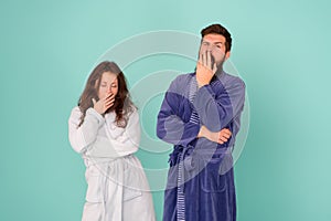 Need more sleep. Yawny couple in love blue background. Sexy woman and bearded man give yawn. Tiredness and fatigue. Yawn