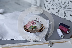 Needle beds embroidered still on fabric with threads and tools