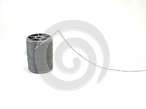 Needle and cord on white background