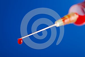 Needle with droplet of blood