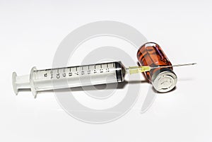 Needle and injection in bottle on white