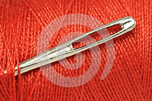 Needle for sewing the coil with a red thread