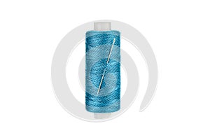 Needle in spool of thread in blue color isolated on white background.