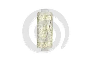 Needle in spool of thread in Tahuna Sands color isolated on white background. Copy space. photo