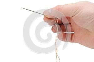 Needle and thread in hand closeup