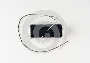 Needle and thread. Needlework object, color cotton thread spool and needle