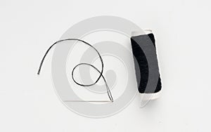 Needle and thread. Needlework object, color cotton thread spool and needle
