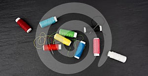 Needle and thread. Needlework object, color cotton thread spool and needle