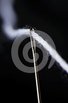 Needle and white thread