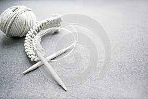 Needlework concept: knitting needles, grey corded cotton yarn, s