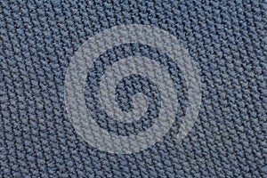 Needlework, hobbies, knitting. Background textile fabric with a knitted texture wool blue. Knitted pattern as background