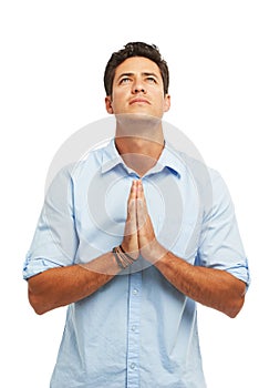 He needs divine intervention. A handsome young man with hands together in prayer against a white background.