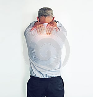He needs a quick pain reliever. Studio shot of a mature man experiencing neck ache against a white background.