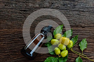 Neem leaf and neem fruit on wooden table. Neem oil is moisturizing oil