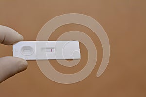 a negative pregnancy HCG test on beige background, Human Chorionic Gonadotropin test, Rapid urine pregnancy test