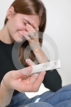 Negative Pregnancy Test. Sad Young Woman