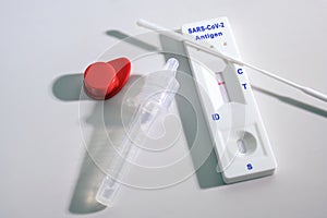 Negative result on a rapid antigen self test kit for covid-19 diagnostic with nasal swabs, tube and detection device, light gray