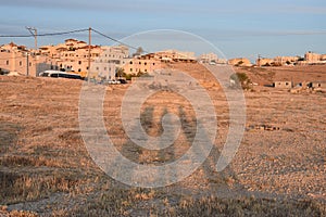 Negev Desert, Arar settlement, three human shadows on the sand at sunset photo