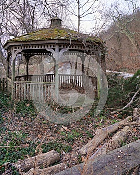 Neglected gazebo stands stolidly over canal