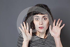 Negligence concept for terrified young brunette woman photo