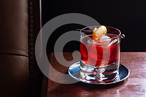 Negroni Cocktail with Ice and Orange Twist in Bar