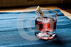 Negroni Cocktail with lemon peel and ice