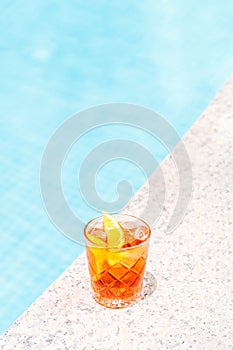 Negroni cocktail near a pool at the resort bar or suite patio. Luxury resort, vacation, room service concept